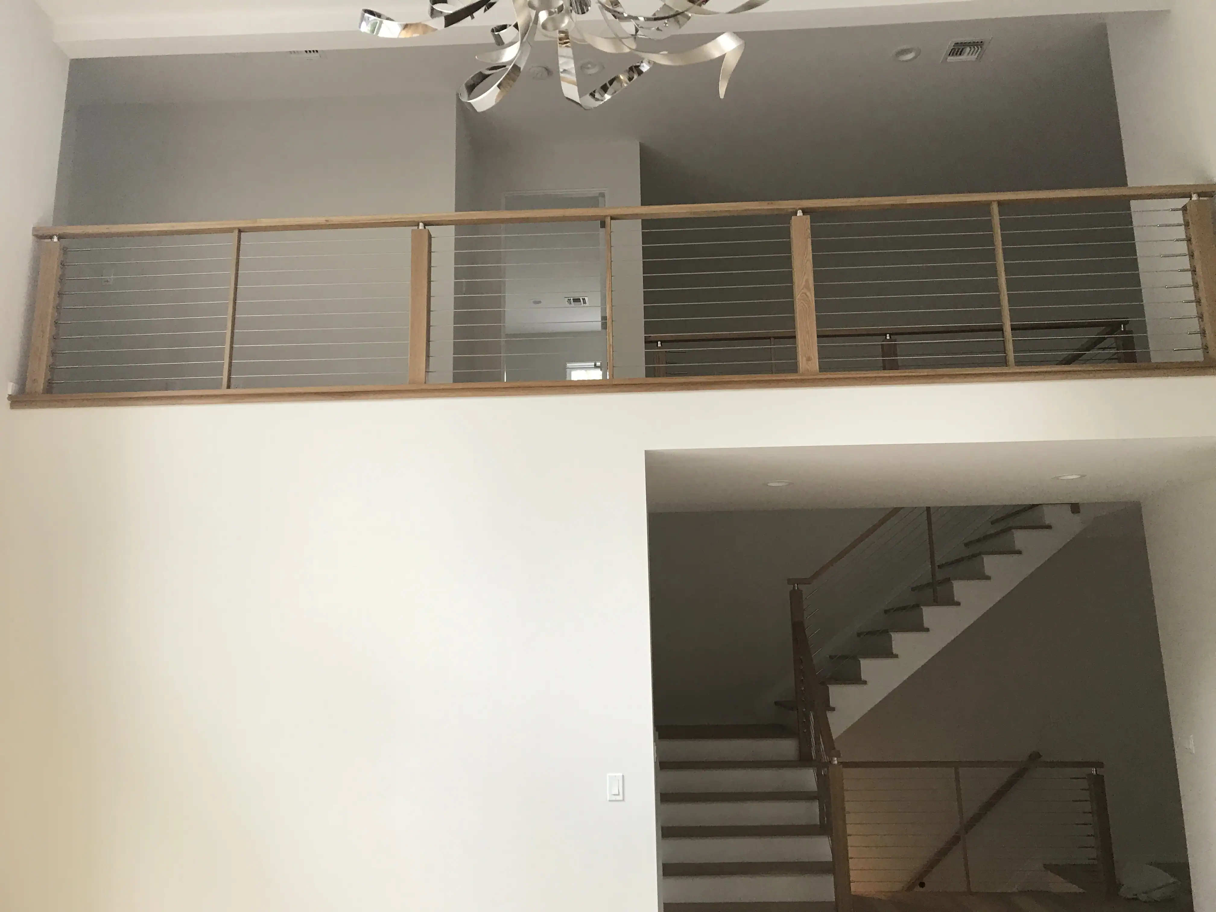Elegant wood and metal railing design for staircases and balconies.