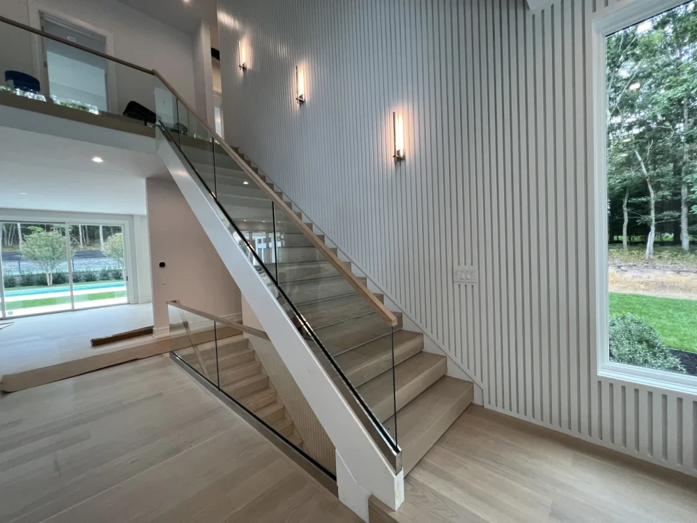 Elegant staircase featuring KG Railings with wood finish, enhancing safety and style in contemporary.