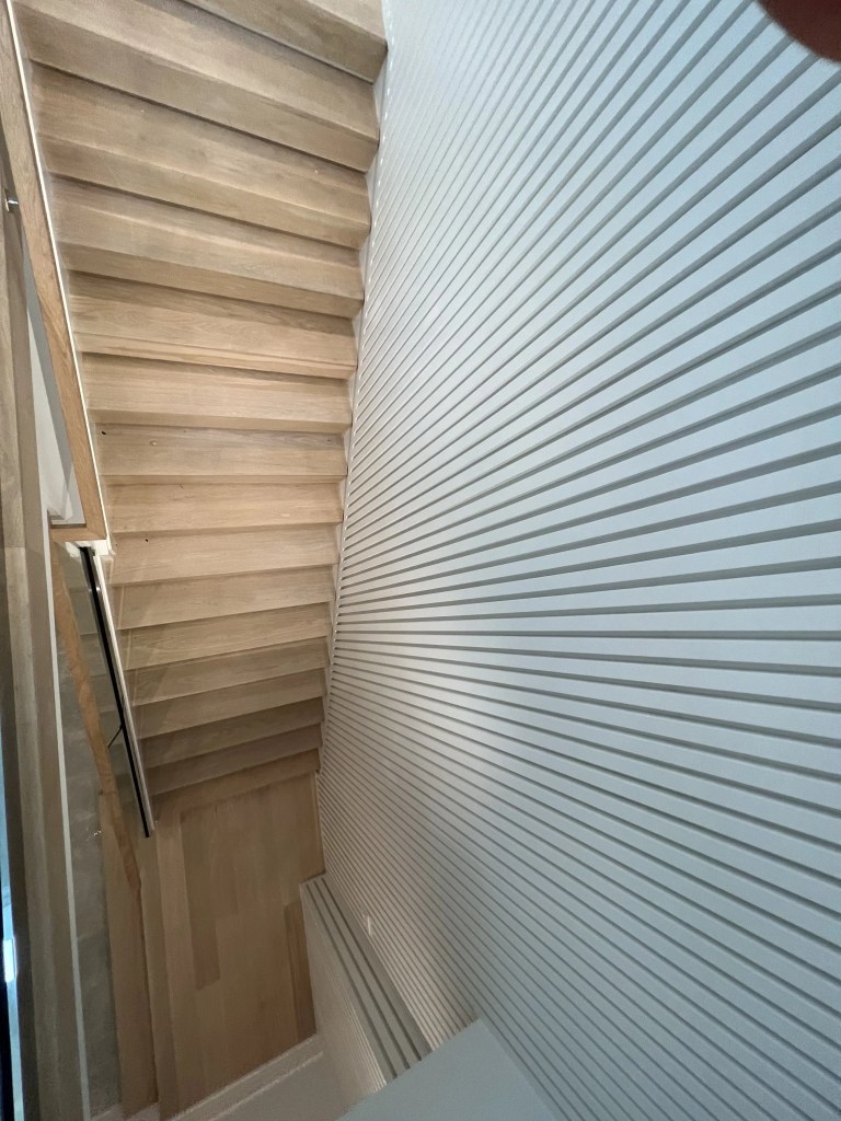 Elegant wood staircase with modern railing design.