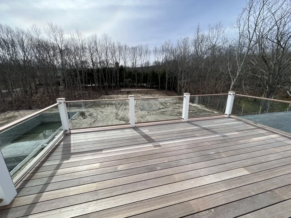 Elegant wooden deck with KG Railings and glass panels for outdoor safety and style.